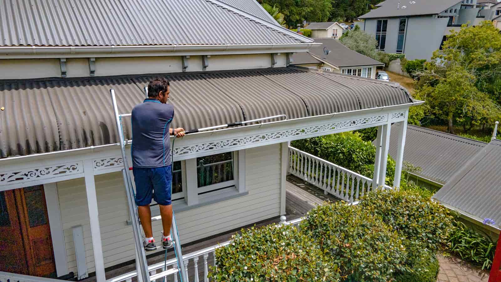Roof access ladder bracket detail integrated with Lindab guttering.