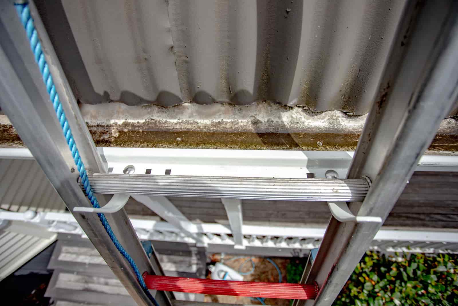 A close-up view of a ladder bracket installed on a completed roofline.