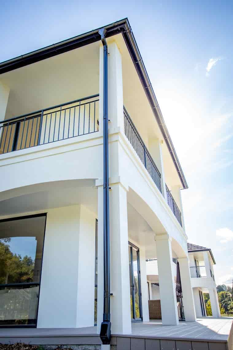 A white house with a balcony, showcasing elegance and charm.