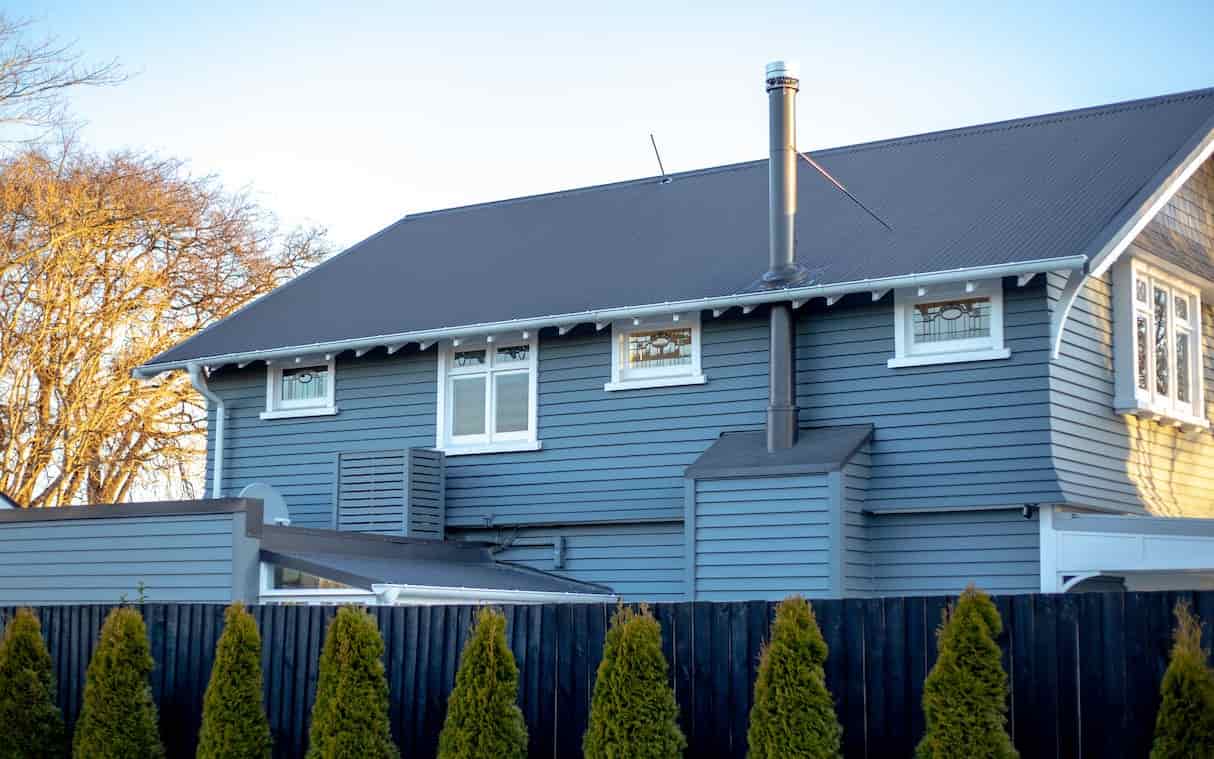 A spacious blue house with a charming exterior, standing tall and commanding attention.
