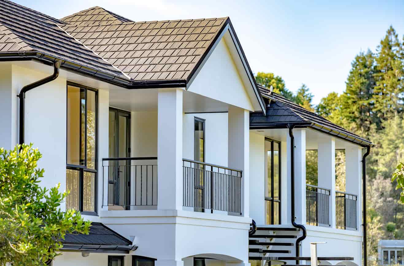 A house with a balcony and railing overlooking the surroundings.